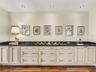 This bank of cabinets with granite countertop in the hallway, adjacent to the kitchen & dining room, is a perfect place for all of your china, special