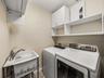 The laundry room has a gas dryer.  Behind the louvers doors is the HVAC unit for the east end of the unit and the hot water heater.