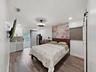 primary bedroom w walk-in closet, new sliding glass doors lead to pool area