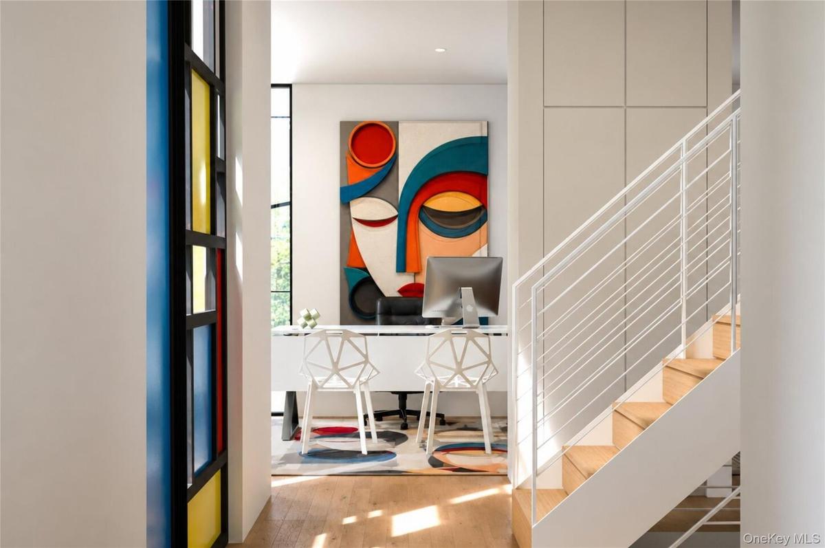 Staircase with clean minimalist lines. Office in the background.