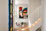 Staircase with clean minimalist lines. Office in the background.