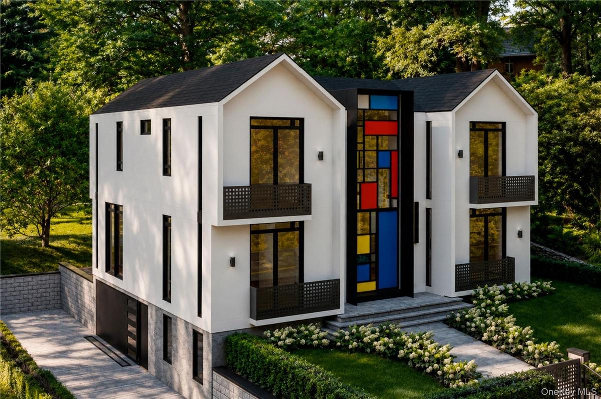 Modern luxury home with an attached two car garage with an extended driveway.