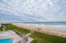 Direct beach access from the building leads to soft sand and surf just steps from your door—coastal living at its finest.