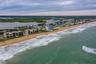 This expansive coastal view looks north along the beach, showcasing the quiet, residential stretch of New Smyrna’s no-drive zone.