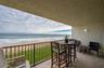 The private covered balcony offers a front-row seat to the Atlantic, with space for dining or lounging while taking in uninterrupted ocean views and t