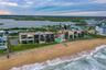 Positioned right on the sand, the oceanfront pool and beach access point are front and center, offering resort-style living with unparalleled coastal 