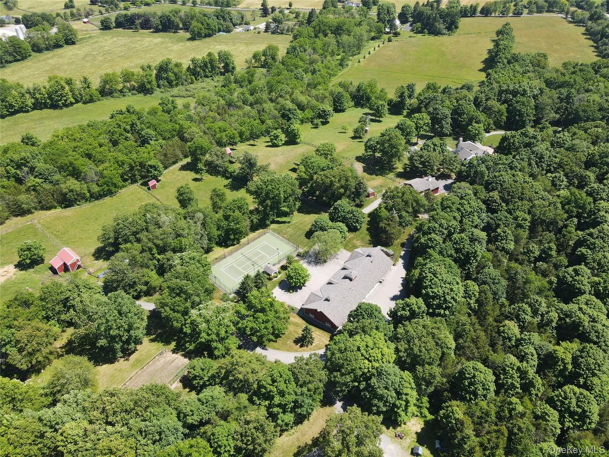 Property aerial showing residence and outbuildings