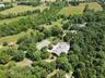 Property aerial showing residence and outbuildings