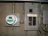 Electrical panel and digital utility meter on a concrete wall