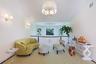 Bright upper-level landing featuring a large bay window, crown molding, and a drum-shade chandelier