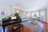 Spacious living area featuring polished wood flooring and a bay window configuration