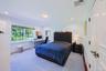 Light-filled room featuring a large window overlooking exterior greenery, crown molding, chair rail molding, recessed lighting, and a paneled interior