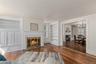 Wood burning fire place in the formal living room open to dining room with pocket doors