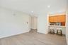 Open-concept living/ dining space featuring European white oak flooring and breakfast bar