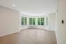 Dining area leads to living room with turreted bay window alcove