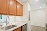 Kitchen featuring new Kohler faucet with pull down spray, sink with hot water dispenser and new dishwasher
