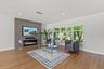 Formal living room features a custom wall with large flat screen TV, electric fireplace, beautiful landscape views from the windows on one side and to