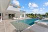Large heated saltwater pool with sun shelf, fountain and spa using Pentair smart technology.