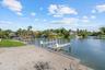 Large sandy beach above the dock walkway can be used for a fire pit, a tiki bar and yard games like horseshoes or cornhole.