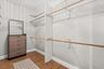 1 of 2 large primary walk-in closets
