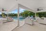 Wrap around covered lanai with multiple seating arrangements.