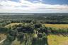 View of property location featuring a forest