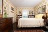 Bedroom with crown molding, wood finished floors, and wallpapered walls