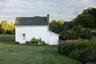 View of side of home featuring a chimney