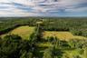 Aerial view of property's location with a forest