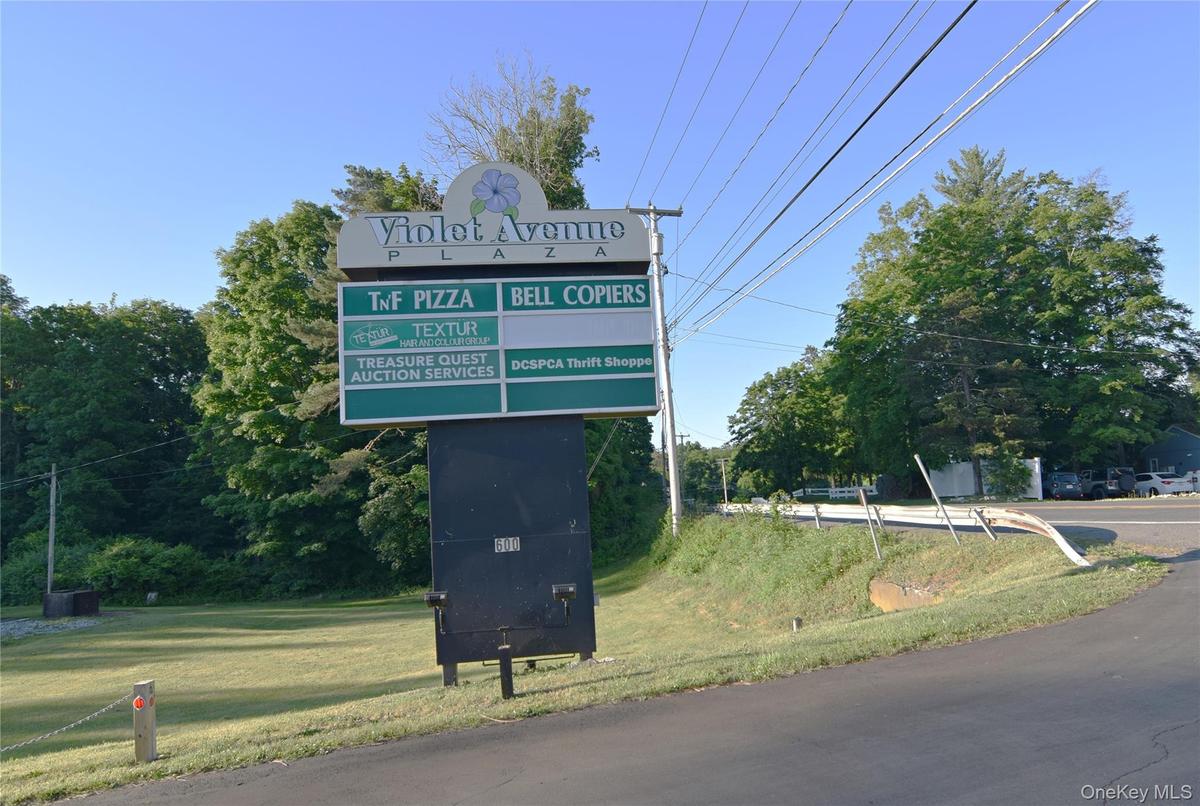 Sign located close to Violet Ave showing business occupants.