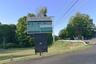 Sign located close to Violet Ave showing business occupants.
