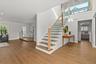 Staircase to second floor primary bedroom, bonus room and 4th bedroom
