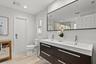 Downstairs bathroom with floating double vanity and shower.