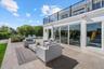 Large travertine patio just outside the kitchen slider; plenty of room for a dining table and chairs.