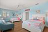 Large upstairs guest bedroom that comfortably accommodates two queen size beds.