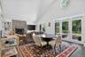 Breakfast room with large windows opening to the outside terrace.