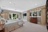 Glorious primary bedroom suite with tranquil views of the gardens.