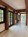 Beamed ceiling  passes deck entry and bay window to sunroom. All windows face Hudson River.