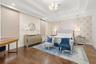 Oversized primary with plenty of room for seating area, high end light fixtures, tasteful decor