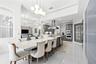 Granite Table in Kitchen perfect for busy mornings or casual dinners, Large sliding pantry doors, french doors to pool area.