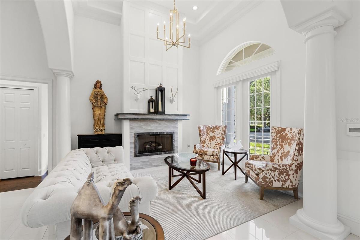 Formal living space with gas fireplace. Access to hall bath and Bed 5 with en suite