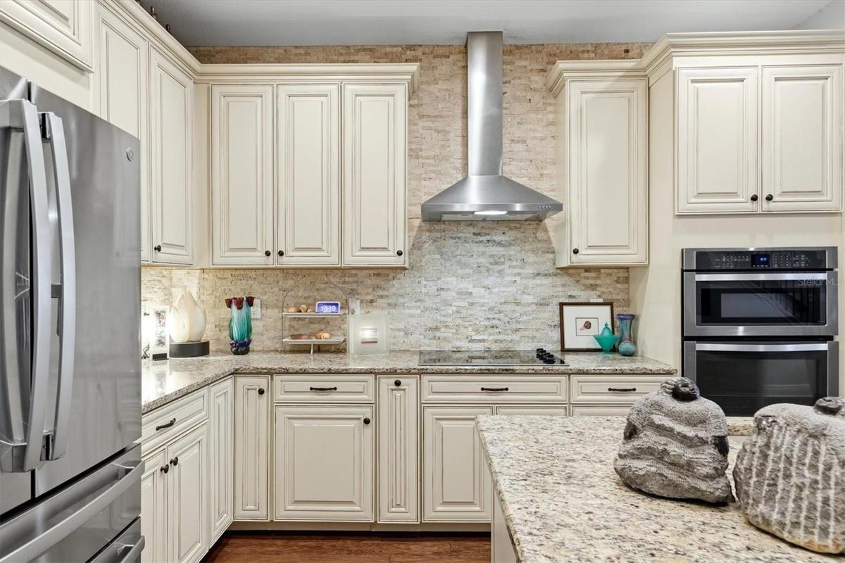The stacked stone backsplash enhances the luxurious feeling of the kitchen