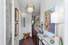 The foyer features a half bath, access to the laundry, the garage and additional storage