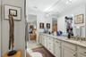 The walk in closet (just visible in the mirror) is spacious