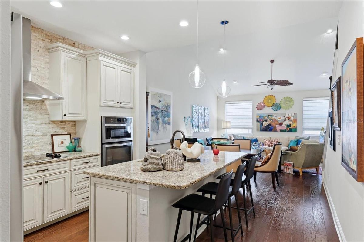The 3 seater breakfast bar frames the quality French Country cabinetry in the kitchen.