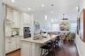 The 3 seater breakfast bar frames the quality French Country cabinetry in the kitchen.