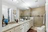 Dual sinks and a glass framed shower