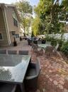 Expansive outdoor brick paver patio featuring a built-in swimming pool and new fence and landscaping 5/2026