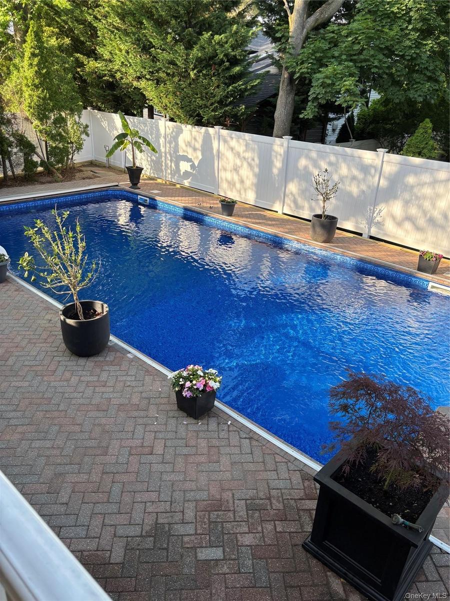 Rectangular in-ground pool with new pool liner, cover, fence, landscaping 5/2026