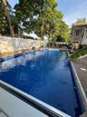Backyard swimming pool with a patterned liner and integrated pool cover newly installed 5/2026